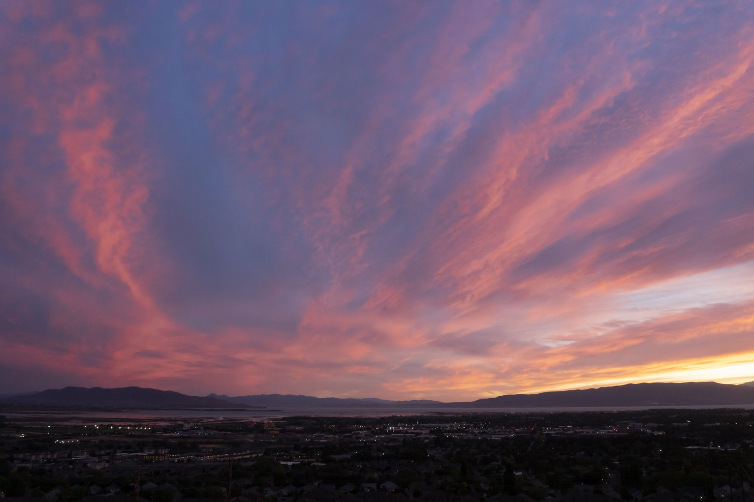 Bright pinks in the clouds out over town and the lake and the mountains